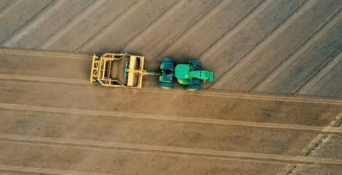 Tractor and scraper — drone view
