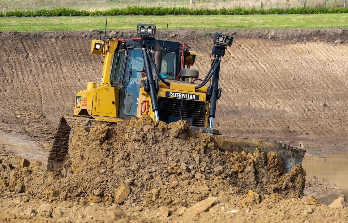 Bulldozer pushing dirt pile