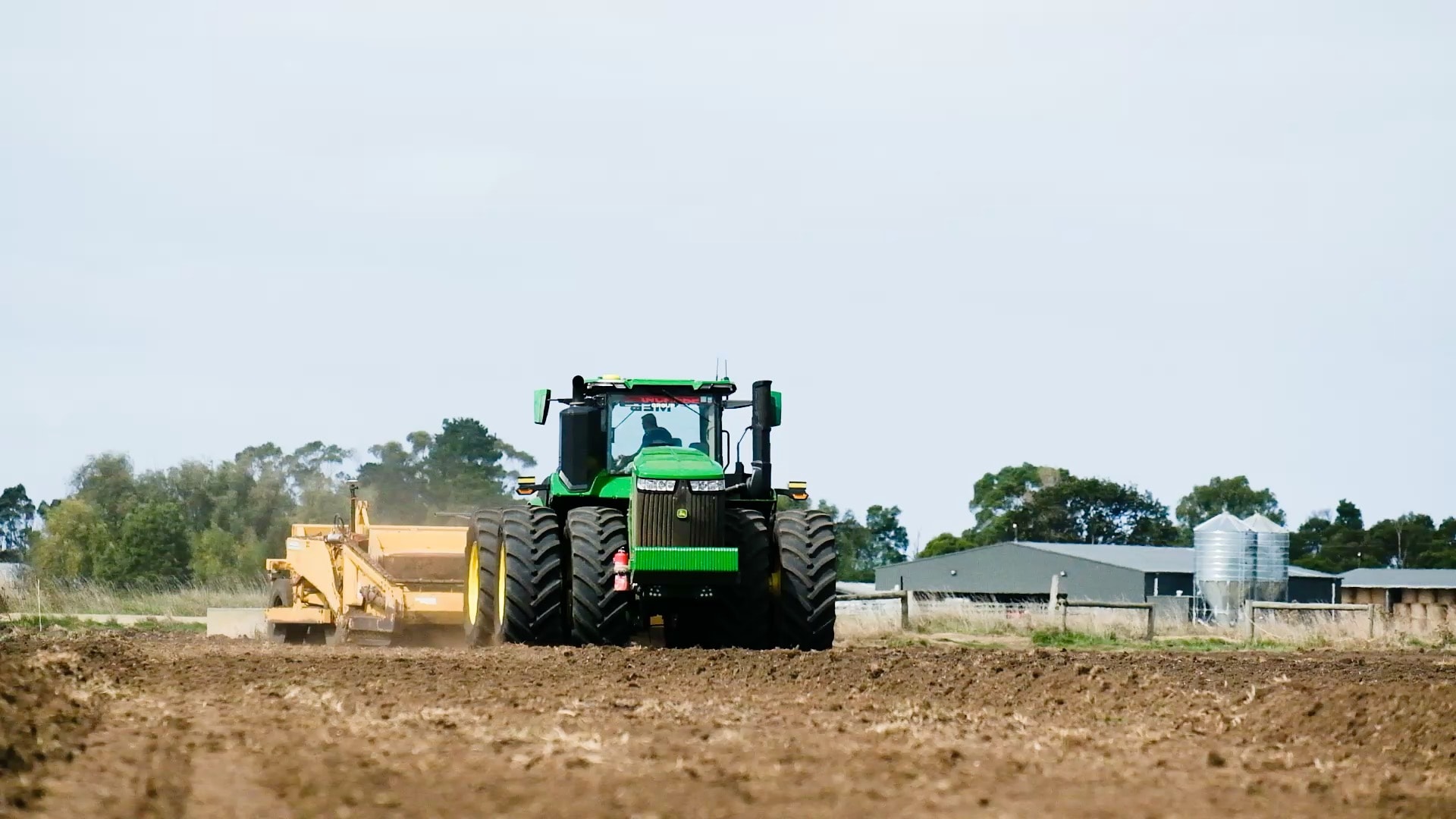 John Deere 9R tractor with scraper