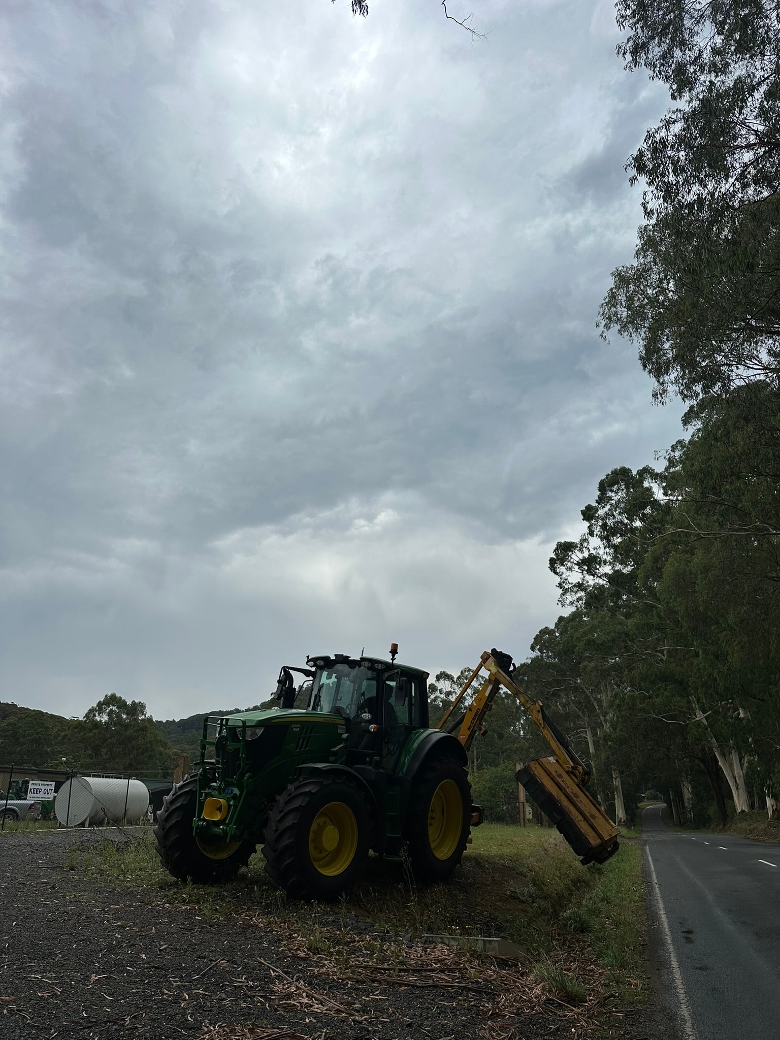 Farm tractor with excavator attachment